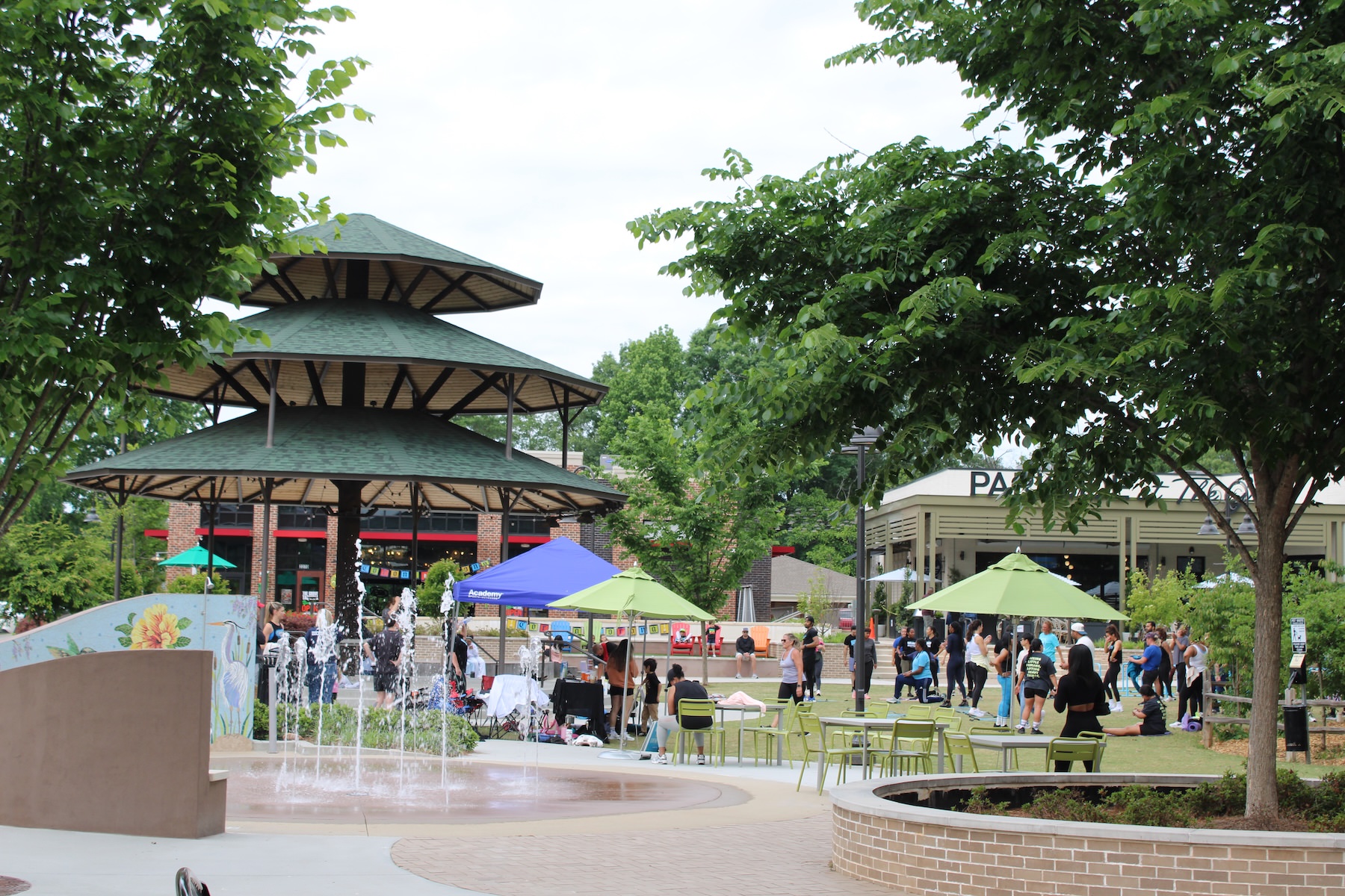 a community park with trees pavilion and splash pad