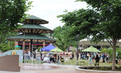 a community park with trees pavilion and splash pad