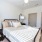 Bedroom with large bed, ensuite. queen bed and nightstands.