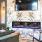 Resident clubhouse with ample seating, fireplace, demo kitchen and TVs