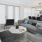 Rendering of spacious living room with gray couch and modern decor