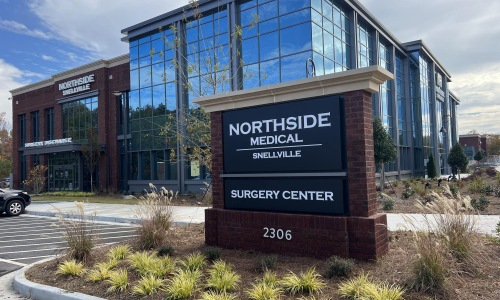 a sign in front of a building with several windows
