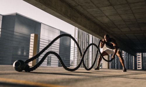 a person working out with ropes in a garage